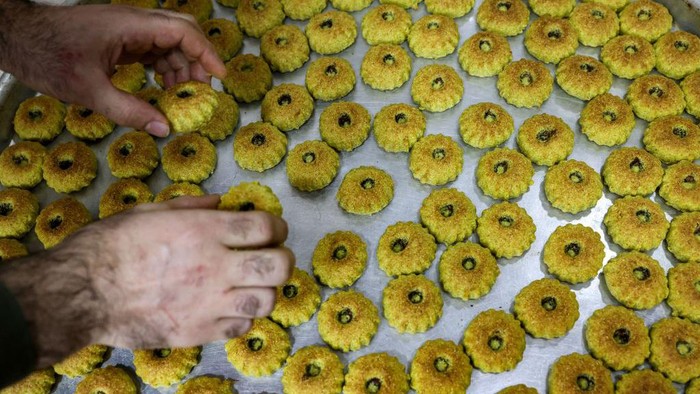 A Palestinian baker lays out fresh 