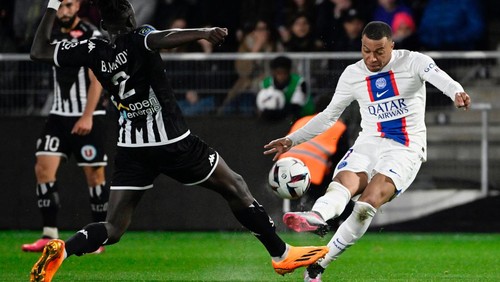 Paris Saint-Germains French forward Kylian Mbappe fights for the ball during the French L1 football match between SCO Angers and Paris Saint-Germain (PSG) at The Raymond-Kopa Stadium in Angers, western France on April 21, 2023. (Photo by DAMIEN MEYER / AFP) (Photo by DAMIEN MEYER/AFP via Getty Images)