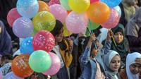 Dua anak asyik bermain balon usai salat Idul Fitri yang menandai akhir bulan Ramadan. Mahmoud Issa/SOPA Images/LightRocket via Getty Images.