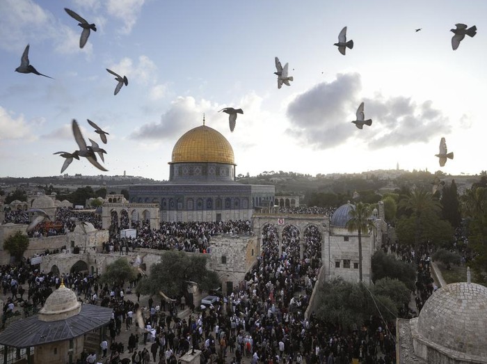 Palestinians attend Eid al-Fitr holiday celebrations by the Dome of the Rock shrine in the Al Aqsa Mosque compound in Jerusalems Old City, Friday, April 21, 2023. The holiday marks the end of the holy month of Ramadan, when devout Muslims fast from sunrise to sunset. (AP Photo/Mahmoud Illean)