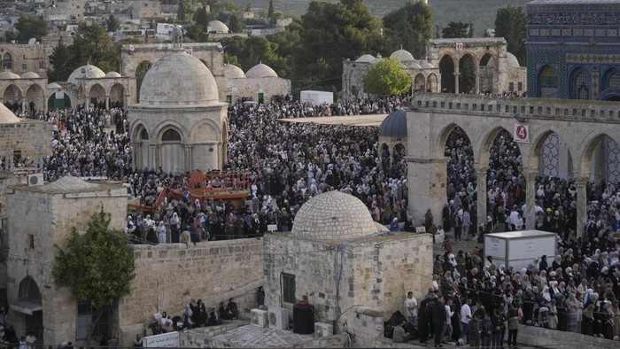 Palestinians attend Eid al-Fitr holiday celebrations at the Al Aqsa Mosque compound in Jerusalem's Old City, Friday, April 21, 2023. The holiday marks the end of the holy month of Ramadan, when devout Muslims fast from sunrise to sunset. (AP Photo/Mahmoud Illean)