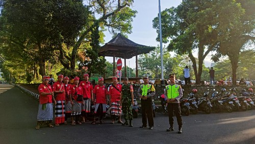 Puluhan pecalang Desa Adat Karangasem bersama TNI, Polri, mengawal salat Id umat muslim di Lapangan Tanah Aron.