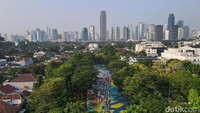 Jemaah melaksanakan salat dalam suasana taman yang asri dan hijau.