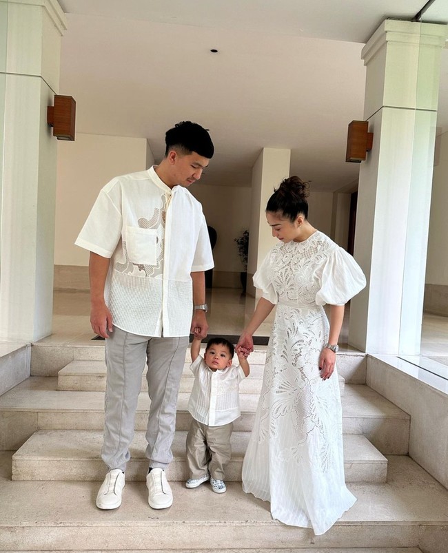 Nikita Willy tampil tak kalah mempesona mengenakan gaun panjang berwarna putih. Penampilannya itu terlihat kompak dengan suami dan anaknya yang juga mengenakan busana berwarna putih. Dengan rambut yang hanya dicepol ke atas, penampilan Nikita pun terlihat simpel. Foto: Instagram