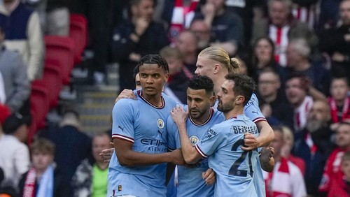 Manchester Citys Riyad Mahrez celebrates with teammates after scoring his sides opening goal during the English FA Cup semi final soccer match between Manchester City and Sheffield United at Wembley stadium, in London, Saturday, April 22, 2023. (AP Photo/Alastair Grant)