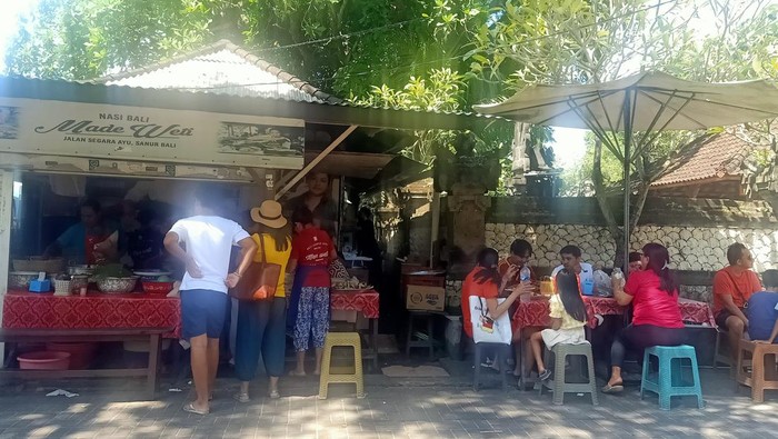 Beberapa customer tampak menunggu untuk mendapatkan pesanan Nasi Bali Made Weti di Warung Nasi Bali Made Weti yang ada di Jalan Segara Ayu, Sanur, Bali pada Senin (24/4/2023).