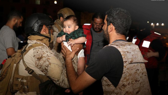 Saudi Royal Navy officers assist a child onboard their navy ship as they evacuate Saudi and other nationals are through Saudi Navy Ship from Sudan to escape the conflicts, Port Sudan, Sudan, April 22, 2023. Saudi Ministry of Defense/Handout via REUTERS ATTENTION EDITORS - THIS PICTURE WAS PROVIDED BY A THIRD PARTY