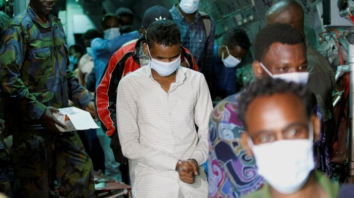 Kenya police officers and civilians rescue an emaciated member of a Christian cult named as Good News International Church, whose members believed they would go to heaven if they starved themselves to death, in Shakahola forest of Kilifi county, Kenya April 24, 2023. REUTERS/Stringer REFILE - QUALITY REPEAT