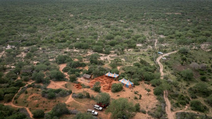 An aerial view shows the mass-grave site in Shakahola, outside the coastal town of Malindi, on April 25, 2023. - Kenyan investigators unearthed another 16 bodies on Tuesday in a forest where a cult was believed to be practising mass starvation, bringing the number of victims so far to 89 including children. There are fears more corpses could be found in Shakahola forest where cult leader Paul Mackenzie Nthenge had allegedly been telling his followers that starvation was the only path to God. (Photo by Yasuyoshi CHIBA / AFP) (Photo by YASUYOSHI CHIBA/AFP via Getty Images)