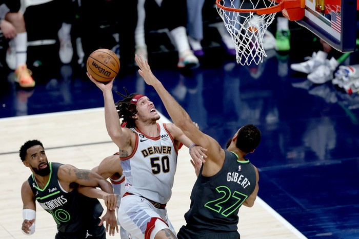 DENVER, COLORADO - APRIL 25: Aaron Gordon #50 of the Denver Nuggets goes to the basket against Rudy Gobert #27 of the Minnesota Timberwolves in the fourth quarter during Round 1 Game 5 of the NBA Playoffs at Ball Arena on April 25, 2023 in Denver, Colorado. NOTE TO USER: User expressly acknowledges and agrees that, by downloading and/or using this photograph, User is consenting to the terms and conditions of the Getty Images License Agreement.  (Photo by Matthew Stockman/Getty Images)