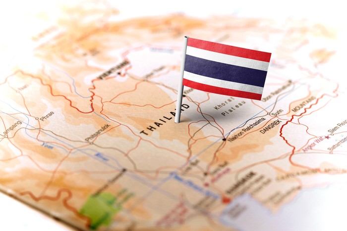 The flag of Thailand pinned on the map. Horizontal orientation. Macro photography.