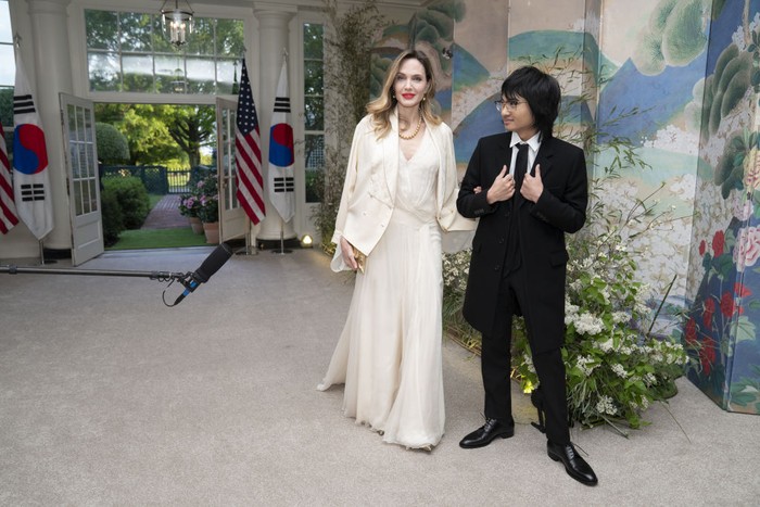 Actress Angelina Jolie, left, and Maddox Jolie-Pitt arrive to attend a state dinner in honor of South Korean President Yoon Suk Yeol and South Korean First Lady Kim Keon Hee hosted by US President Joe Biden and First Lady Jill Biden at the White House in Washington, DC, US, on Wednesday, April 26, 2023. The US will strengthen the deterrence it provides South Korea against nuclear threats, securing a pledge from Seoul to honor commitments to not pursue its own atomic arsenal. Photographer: Sarah Silbiger/Bloomberg via Getty Images