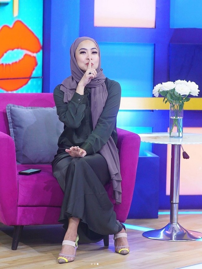 Dalam foto ini, instruktur tari tradisional ini memakai hijab pashmina instan warna taro dipadu dengan kemeja dan rok hitam. Feni membentuk hijab yang hanya disampirkan satu sisi ke belakang pundak, saat membawakan acara Rumpi. Foto: Dok. Instagram @fenirose.