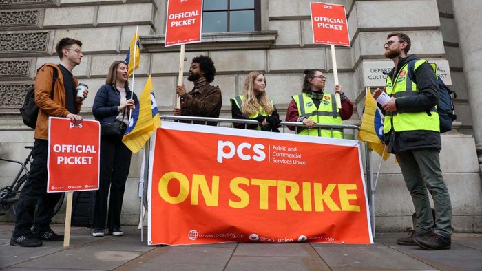 Hollie Adams/Bloomberg via Getty Images A striking civil servant on a picket line outside the Department for Education in London, UK, on Friday, April 28, 2023. More than 120,000 PCS, main union for civil servants, members plan to strike on April 28, and the union is re-balloting its members to extend a mandate for industrial action beyond May. Photographer: Hollie Adams/Bloomberg via Getty Images