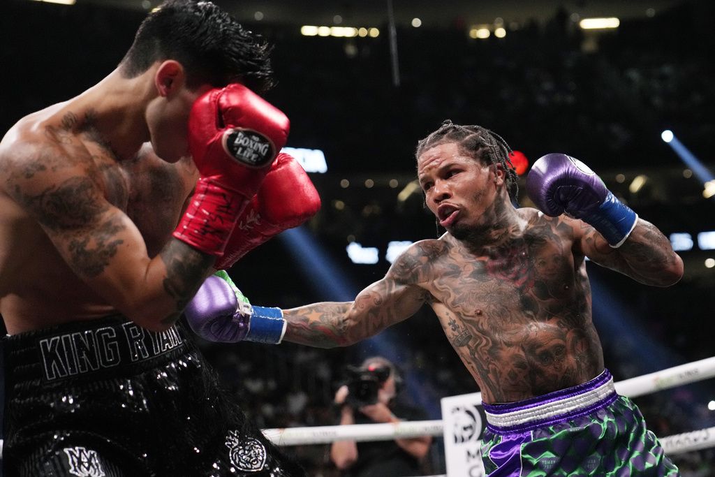 Gervonta Davis, right, swings at Ryan Garcia during a lightweight boxing bout Saturday, April 22, 2023, in Las Vegas. (AP Photo/John Locher)