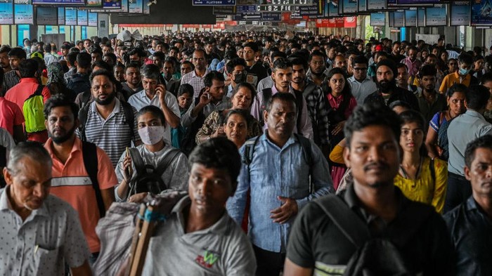 1252235437 Commuters walk on an over-bridge at a railway station in Mumbai on April 27, 2023. India is projected to overtake China as the world's most populous country during the current month, April of 2023, reported John Wilmoth, director of United Nations' (UN) Population Division. (Photo by Sankhadeep Banerjee/NurPhoto via Getty Images)
