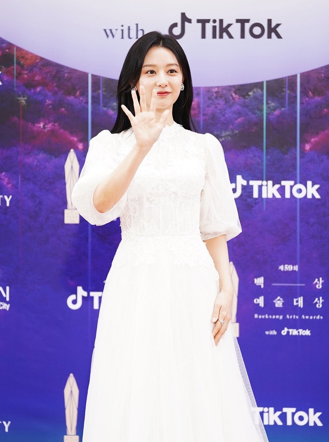 Kim Ji Won tampil elegan dengan gaun bergaya Victorian. Kerah tinggi dengan lengan bervolume menjadikan gayanya lebih anggun. Foto: Twitter/@TikTok_Korea, Instagram/@koreadispatch