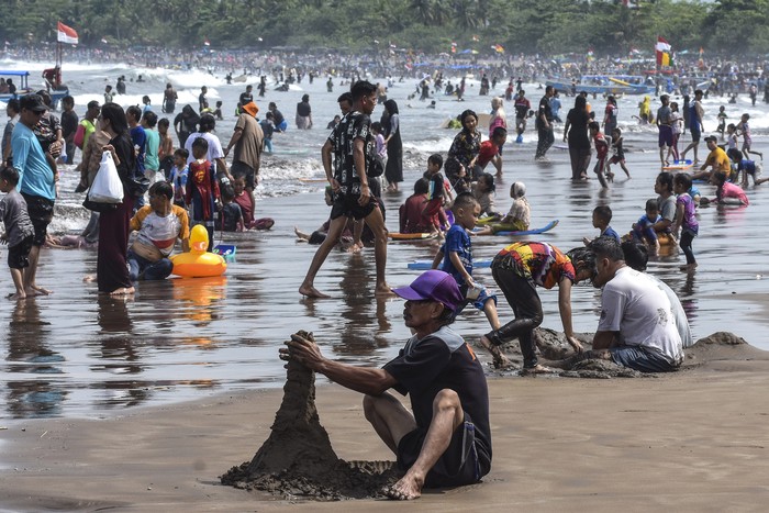 Pengunjung memadati pesisir pantai barat di Kabupaten Pangandaran, Jawa Barat, Sabtu (29/4/2023). Dinas Pariwisata dan Kebudayaan Kabupaten Pangandaran menyebutkan jumlah kunjungan wisatawan selama libur Lebaran yang masuk di lima objek wisata Pangandaran mencapai sekitar 50.000 pengunjung. ANTARA FOTO/Adeng Bustomi/pras.