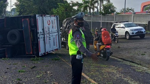 Sebuah truk ekspedisi terguling di jalur Denpasar-Gilimanuk, tepatnya di Desa Megati, Kecamatan Selemadeg Timur, Tabanan, Bali, Senin (1/5/2023) pagi.