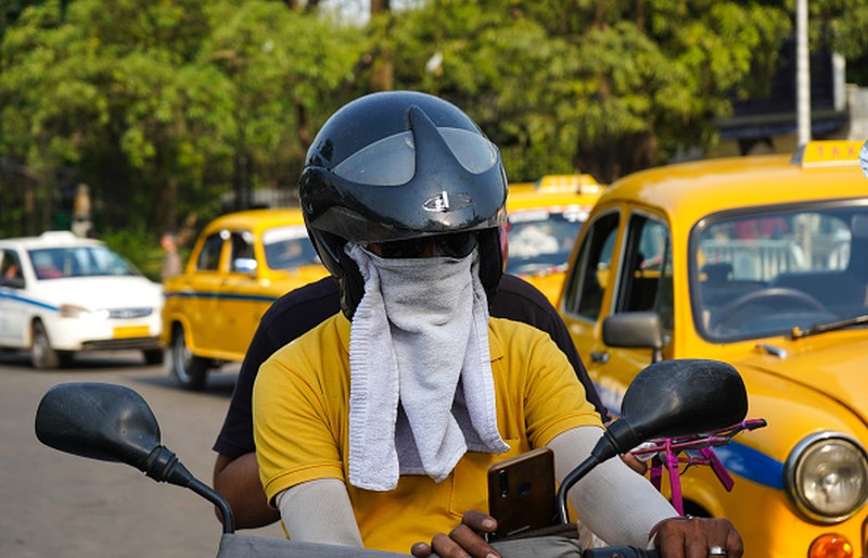 A taxi driver is seen drinking water from a bottle during afternoon heat in Kolkata , India , on 18 April 2023 . Temperature sore well above 40 Celsius as IMD has announces that heat wave will continue till the end of late on the second week of April as India experiences its highest temperature of April in nearly a decade according to report. (Photo by Debarchan Chatterjee/NurPhoto via Getty Images)