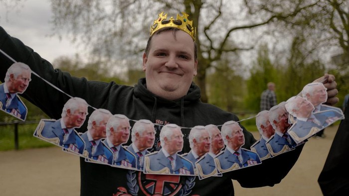Aksi Fans Keluarga Kerajaan Berkemah Jelang Penobatan Raja Charles III Royal enthusiasts attached flags to the barriers as they camp along the Mall, ahead of the coronation of Britain's King Charles III, in London, Sunday, April 30, 2023. (AP Photo/Alberto Pezzali)