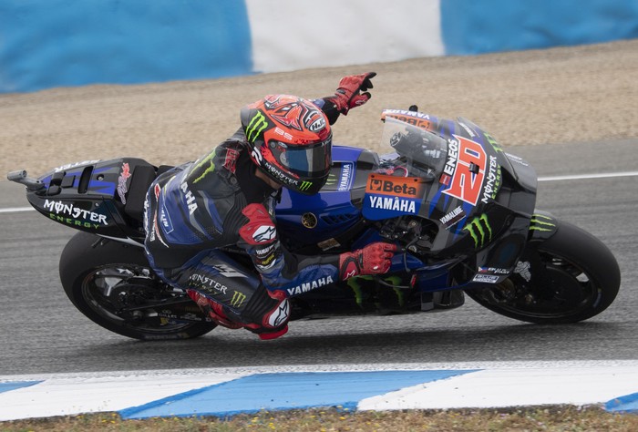 JEREZ DE LA FRONTERA, SPAIN - APRIL 30: Fabio Quartararo of France and Monster Energy Yamaha MotoGP Team greets the fans  and rounds the bend during the MotoGP wurm up  during the MotoGP Of Spain - Race on April 30, 2023 in Jerez de la Frontera, Spain. (Photo by Mirco Lazzari gp/Getty Images)