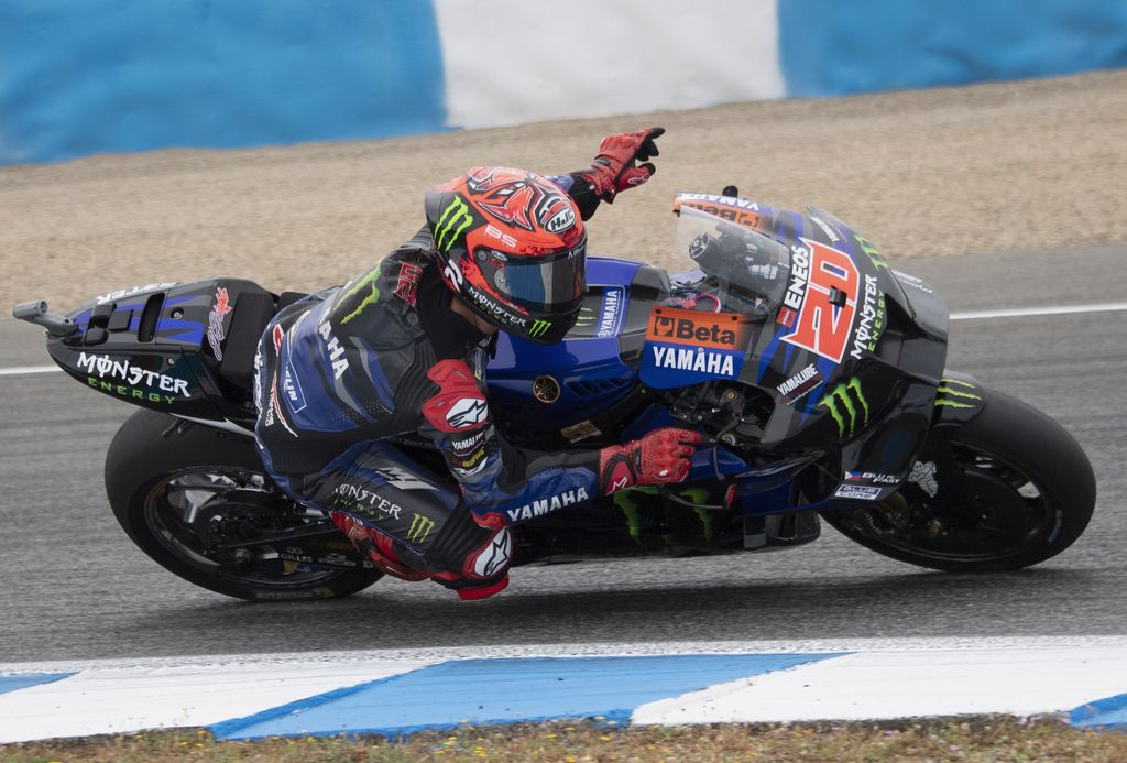 JEREZ DE LA FRONTERA, SPAIN - APRIL 30: Fabio Quartararo of France and Monster Energy Yamaha MotoGP Team greets the fans  and rounds the bend during the MotoGP wurm up  during the MotoGP Of Spain - Race on April 30, 2023 in Jerez de la Frontera, Spain. (Photo by Mirco Lazzari gp/Getty Images)