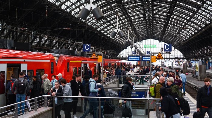 A general view of travelers is seen on the platform of Cologne Central Station during the first day of the nationwide 49 Euro ticket on May 1, 2023 (Photo by Ying Tang/NurPhoto via Getty Images).