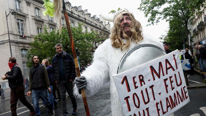 A man dressed in a costume attends the traditional May Day labour march, a day of mobilisation against the French pension reform law and for social justice, in Paris, France May 1, 2023. REUTERS/Benoit Tessier
