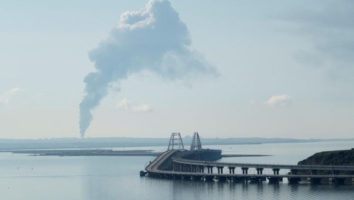 A view across the Kerch Strait shows smoke rising above a fuel depot near the Crimean bridge in the village of Volna in Russias Krasnodar region as seen from a coastline in Crimea, May 3, 2023. REUTERS/Stringer