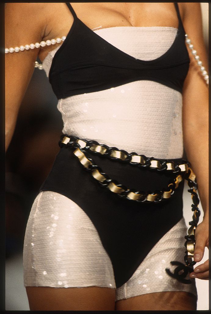 Chanel Spring 1994 Ready To Wear PARIS, FRANCE - OCTOBER: A model walks the runway during the Chanel Ready to Wear show as part of Paris Fashion Week Spring/Summer 1994-1995 in October, 1994 in Paris, France. (Photo by Victor VIRGILE/Gamma-Rapho via Getty Images)