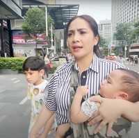 Ketika berjalan-jalan di Singapura Nagitaa juga sempat terlihat momong kedua anaknya sendiri. Sambil menggendong Rayyanza, Nagita menggandeng Rafathar. Foto: YouTube/Rans Entertainment