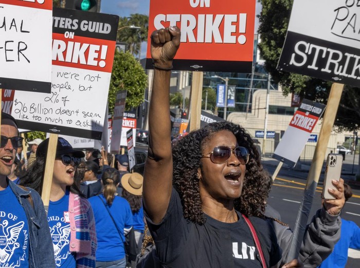 LOS ANGELES, CA - MAY 02: People picket outside of Paramount Pictures on the first day of the Hollywood writers strike on May 2, 2023 in Los Angeles. Scripted TV series, late-night talk shows, film and streaming productions are being interrupted by the Writers Guild of America (WGA) strike. In 2007 and 2008, a WGA strike shut down Hollywood productions for 100 days, costing the local economy between $2 billion and $3 billion. (Photo by David McNew/Getty Images)
