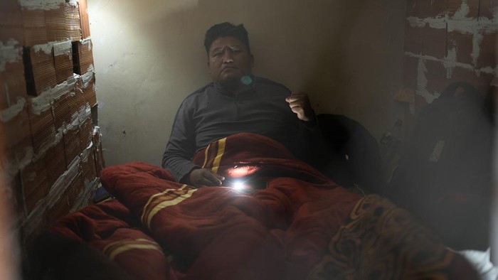 Wilfredo Ajllahuanca sits inside a structure built from within by three educators on hunger strike who walled themselves inside of it at the teachers union headquarters in La Paz, Bolivia, Tuesday, May 2, 2023. Three leaders in public education began a hunger strike on May 1 after two months of ongoing protests by teachers demanding a higher budget for public education and to protest the new educational curriculum. (AP Photo/Juan Karita)