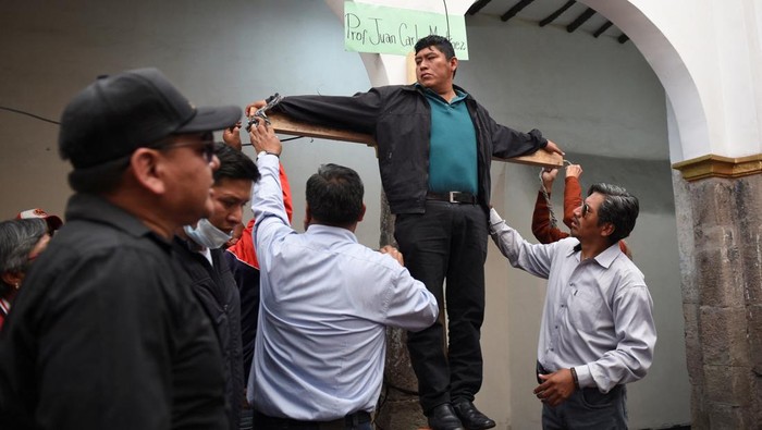 Protes Kurikulum Baru, Guru di Bolivia Kurung Diri dan Mogok Makan Teacher Wilfredo Ajllahuanca seals himself behind a wall to carry out a dry hunger strike to protest a new curriculum established by Bolivia's Ministry of Education, in La Paz, Bolivia May 1, 2023. (REUTERS/Claudia Morales)