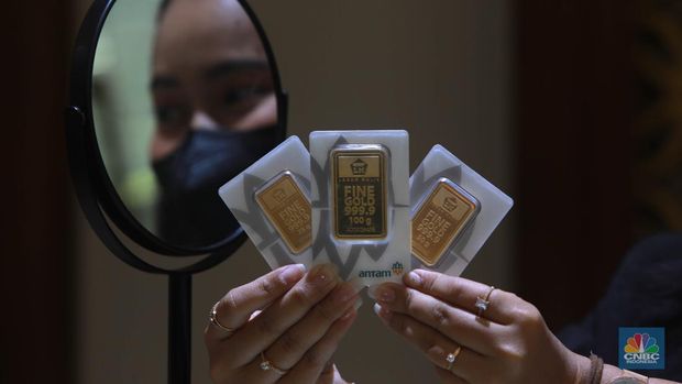 Karyawati menunjukkan emas PT Aneka Tambang Tbk. (Antam) di salah satu gallery penjualan emas di Jakarta, Kamis (4/5). (CNBC Indonesia/Muhammad Sabki)