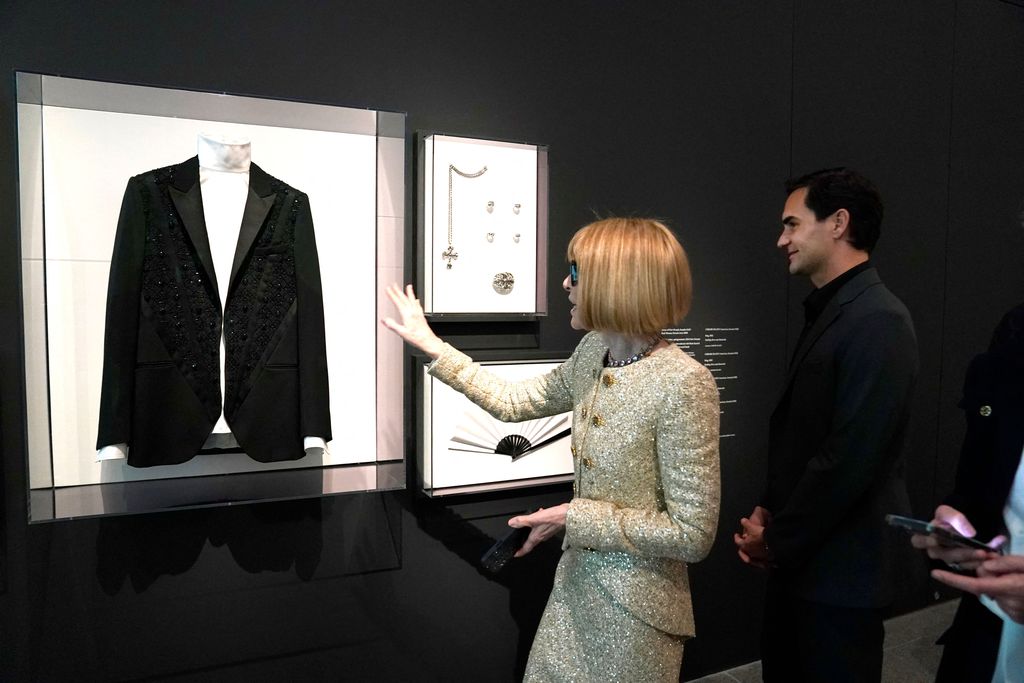 English magazine editor Anna Wintour and Swiss tennis player Roger Federer, look at items of Karl Lagerfeld on display during the press preview of The Costume Institute's exhibition titled Karl Lagerfeld: A Line of Beauty, at The Metropolitan Museum of Art in New York City on May 1, 2023. (Photo by TIMOTHY A. CLARY / AFP) (Photo by TIMOTHY A. CLARY/AFP via Getty Images)