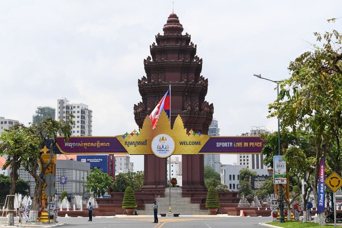 Police officers stand guard under a gate ahead of the 32nd Southeast Asian Games (SEA Games) in Phnom Penh on May 4, 2023. (Photo by Nhac NGUYEN / AFP) (Photo by NHAC NGUYEN/AFP via Getty Images)