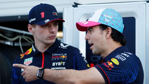 MIAMI, FLORIDA - MAY 04: Sergio Perez of Mexico and Oracle Red Bull Racing and Max Verstappen of the Netherlands and Oracle Red Bull Racing talk ahead of unveiling the one off livery for the Red Bull Racing RB19 designed by Martina Andriano during previews ahead of the F1 Grand Prix of Miami at Miami International Autodrome on May 04, 2023 in Miami, Florida. (Photo by Chris Graythen/Getty Images)