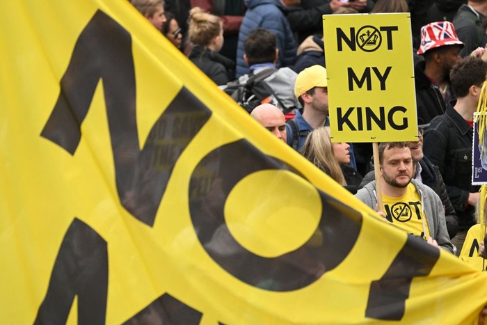 TOPSHOT - Protesters hold up placards saying 'Not My King' in Trafalgar Square close to where Britain's King Charles III and Britain's Camilla, Queen Consort will be crowned at Westminster Abbey in central London on May 6, 2023. - The set-piece coronation is the first in Britain in 70 years, and only the second in history to be televised. Charles will be the 40th reigning monarch to be crowned at the central London church since King William I in 1066. Republican opponents who want an elected head of state plan to protest on the day with signs declaring 