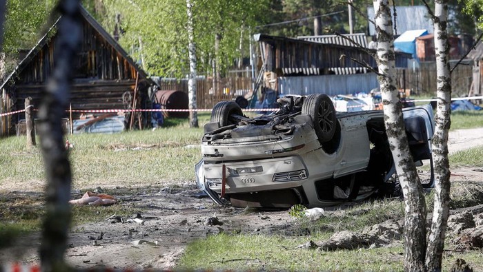 A view shows a damaged white Audi Q7 car lying overturned on a track next to a wood, after Russian nationalist writer Zakhar Prilepin was allegedly wounded in a bomb attack in a village in the Nizhny Novgorod region, Russia, May 6, 2023. REUTERS/Anastasia Makarycheva