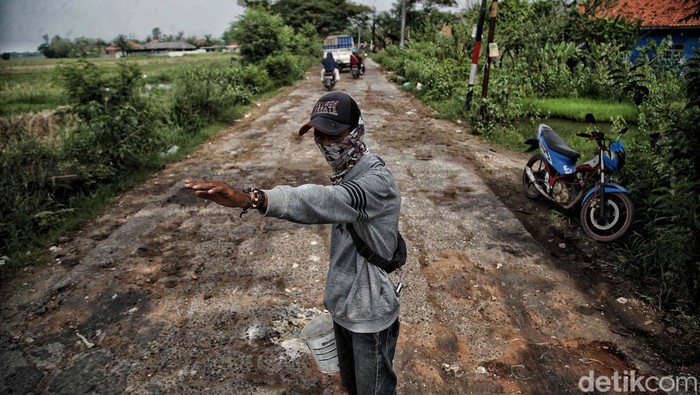 Jalan Raya Kali CBL, Cibitung, Kabupaten Bekasi, rusak dan tergenang air. Jalan yang rusak mencapai 10 Km.
