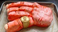 Jari bengkak Raja Charles III dalam acara penobatan di Westminster Abbey, London jadi perhatian. Seorang netizen pun kreatif membuat kue bentuk jari Raja Charles III yang juga memerah. Foto: Twitter @sharkyape