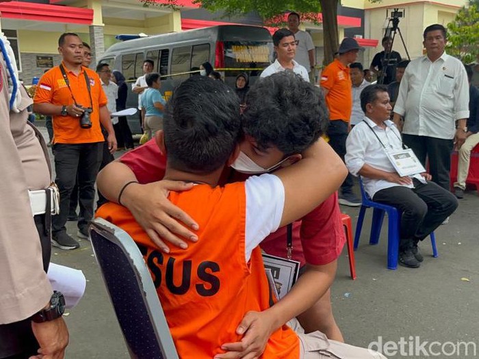 Momen AKBP Achiruddin berpelukan dengan anaknya, Aditya Hasibuan.