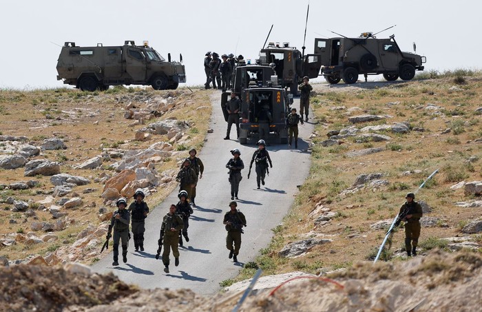 Israeli troops take position during clashes between Palestinians and Israeli troops after Israeli machinery demolish a school near Bethlehem in the Israeli-occupied West Bank May 7, 2023. REUTERS/Mussa Qawasma