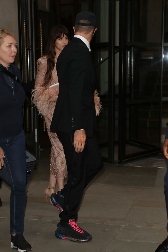 LONDON, ENGLAND - OCTOBER 13: Chris Martin and Dakota Johnson seen leaving The Corinthia Hotel ahead of the 