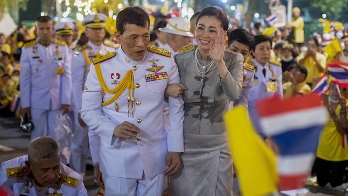King Maha Vajiralongkorn, center left and Queen Suthida, center right wave to supporters in Bangkok, Thailand, Sunday, Nov. 1, 2020. Under increasing pressure from protesters demanding reforms to the monarchy, Thailands king and queen met Sunday with thousands of adoring supporters in Bangkok, mixing with citizens in the street after attending a religious ceremony inside the Grand Palace. (AP Photo/Wason Wanichakorn)
