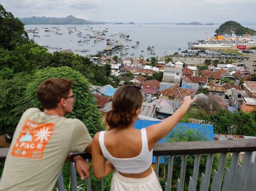 Tourists enjoy the view of Marina Labuan Bajo ahead of the Association of Southeast Asian Nations (ASEAN) Summit in Labuan Bajo, on May 9, 2023. (Photo by WILLY KURNIAWAN / POOL / AFP) (Photo by WILLY KURNIAWAN/POOL/AFP via Getty Images)
