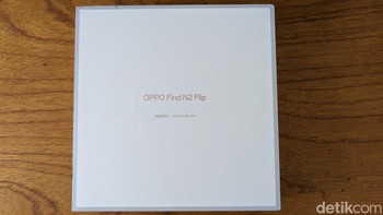Ini kotak kemasan Oppo Find N2 Flip yang terlihat sangat mewah dengan paduan warna putih gading, abu-abu, dan emas. Ukuran kotak kemasannya terbilang sangat besar untuk ponsel sekecil ini. Foto: Virgina Maulita Putri/detikINET