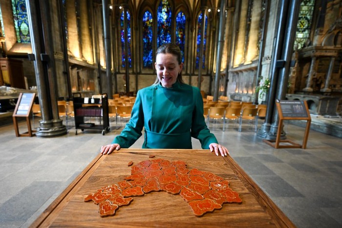 SALISBURY, ENGLAND - MAY 10: Jeffrey Gibson’s textile work ‘They Want to be Free 2021’ which reflects his Choctaw-Cherokee heritage is hung by staff at the 'To Be Free' Art Exhibition At Salisbury Cathedral, on May 10, 2023 in Salisbury, England. The work on show is by leading contemporary artists Ai Weiwei, Yinka Shonibare, Mona Hatoum and Cornelia Parker, and its theme asks us to reflect on rights and freedoms most of us take for granted, and to consider what it means to be free and how you can use your freedoms to the aid of others. 